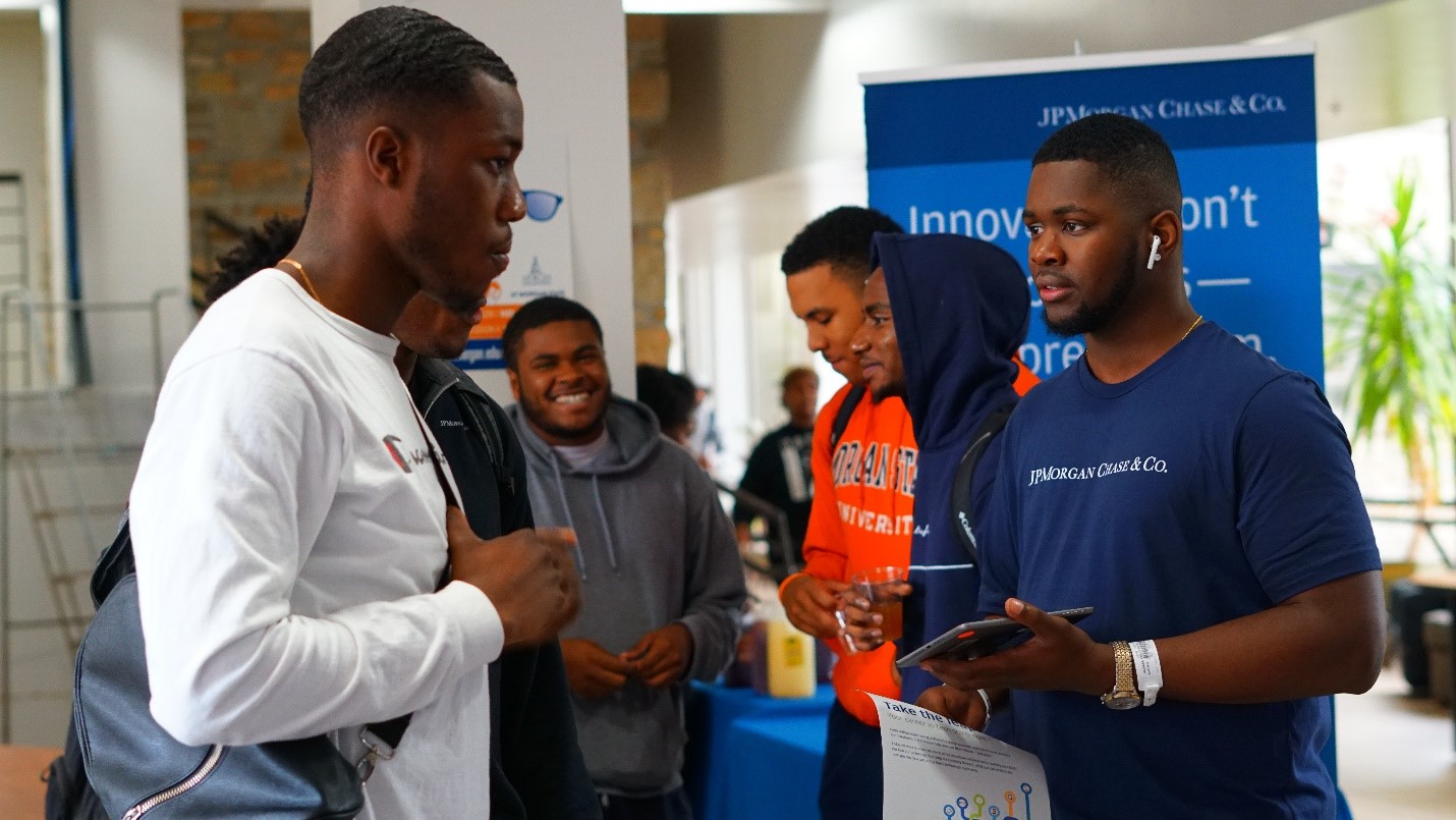 A JP Morgan Chase representative speaks with a student about development opportunities. Photo courtesy of JP Morgan Chase & Co.