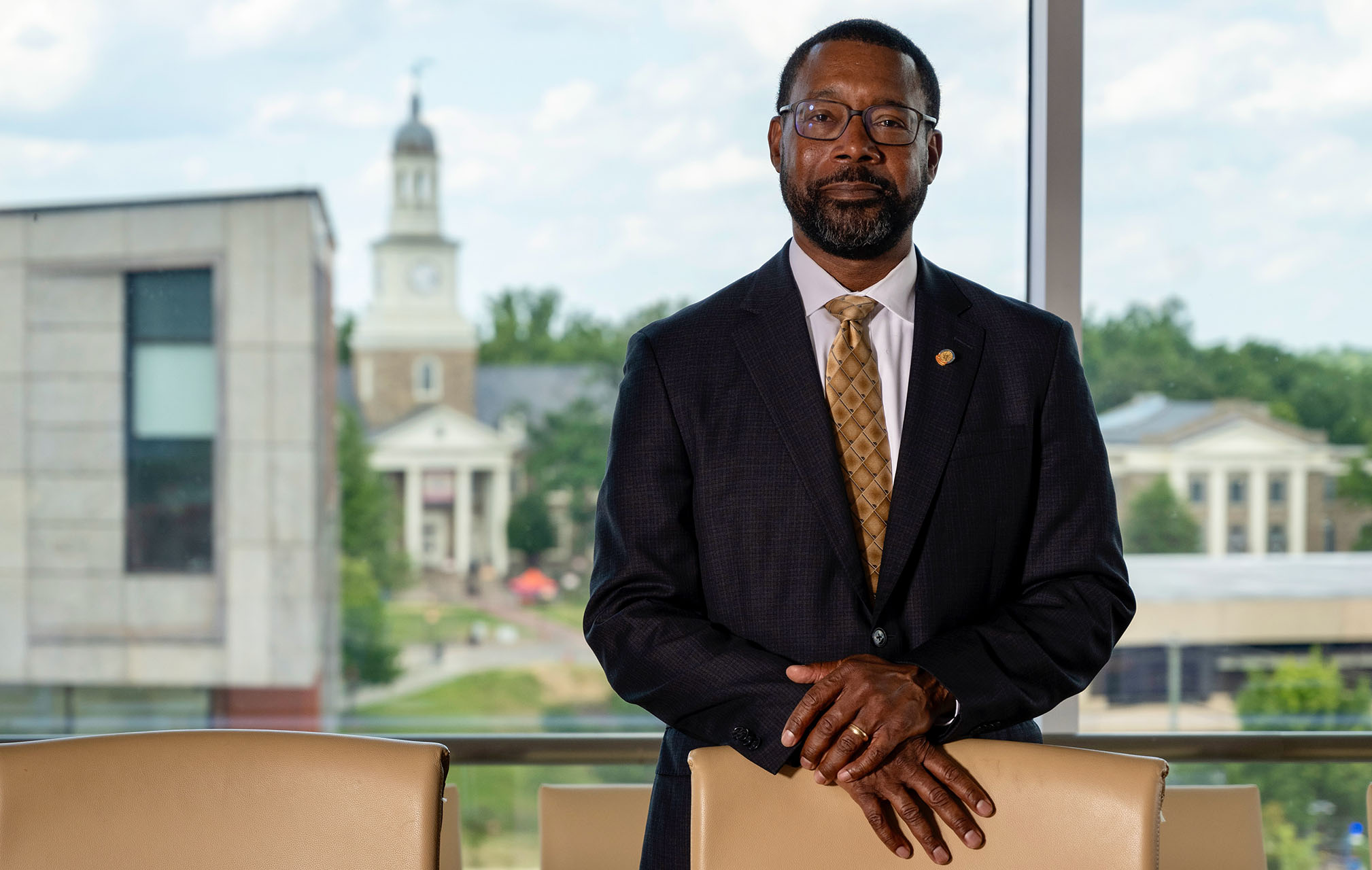 Foundation Board Chair Joseph Simms III standing behind an executive chair