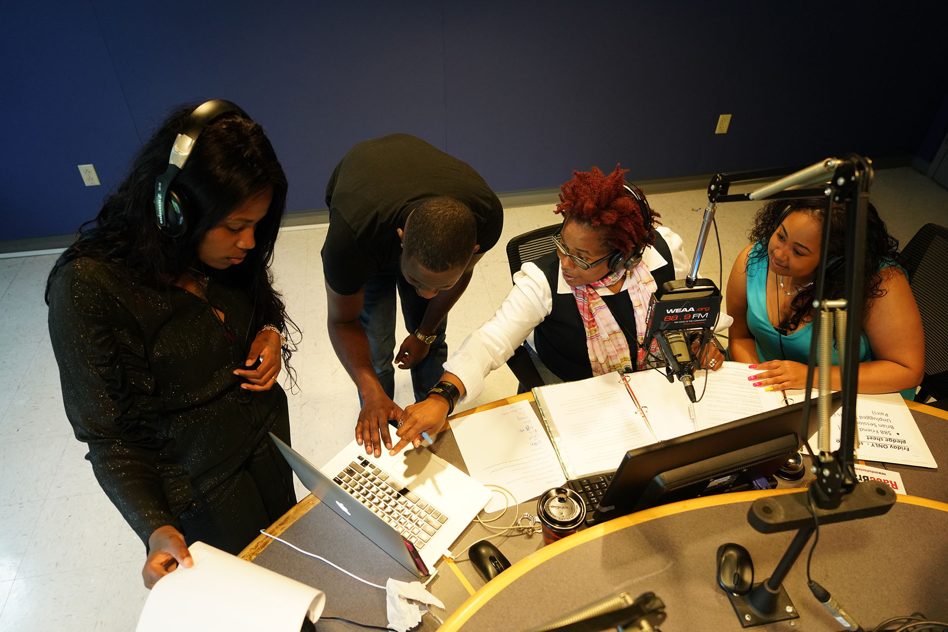 students with staffer inside WEAA studio