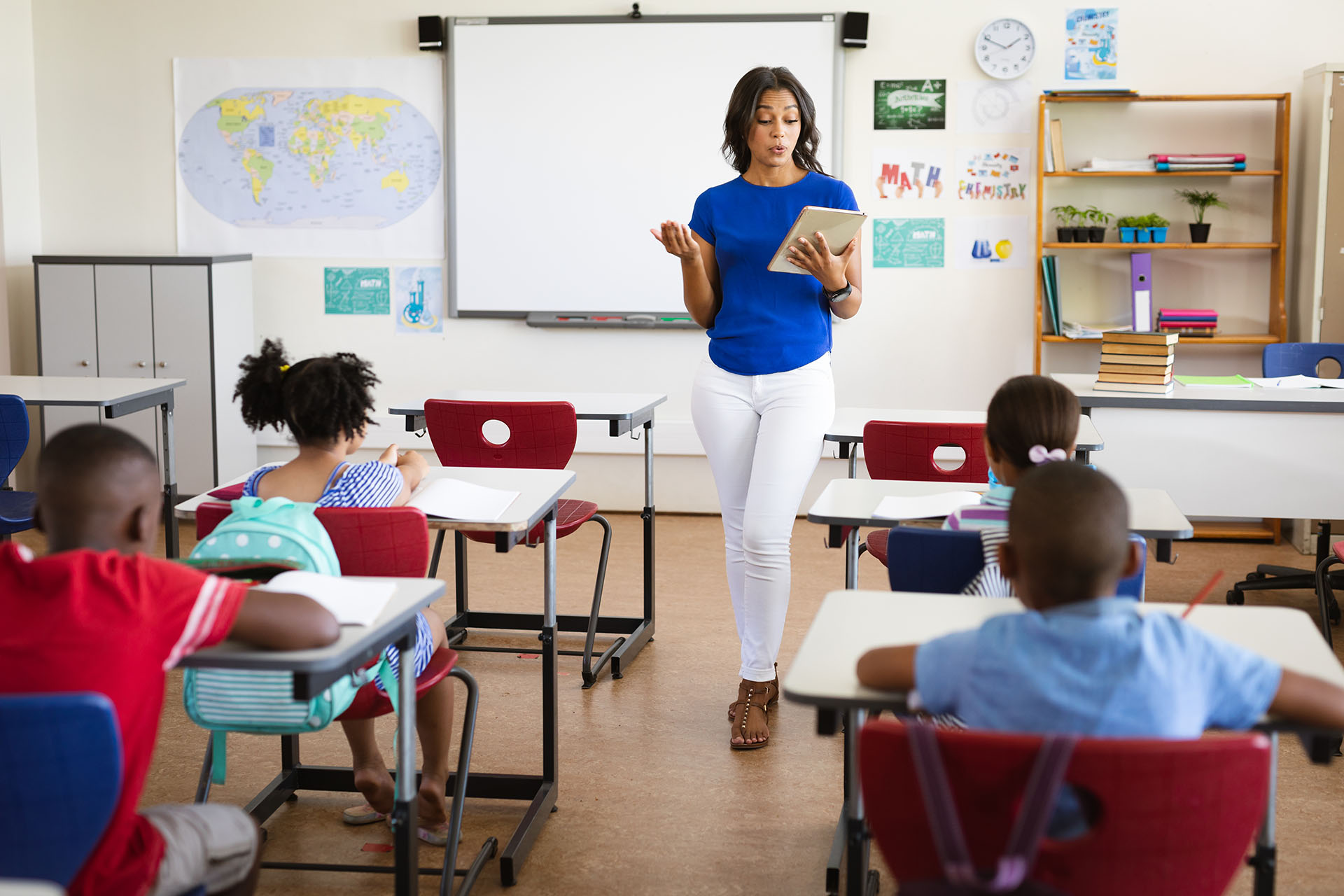 Classroom instruction, teacher guiding students through a reading session
