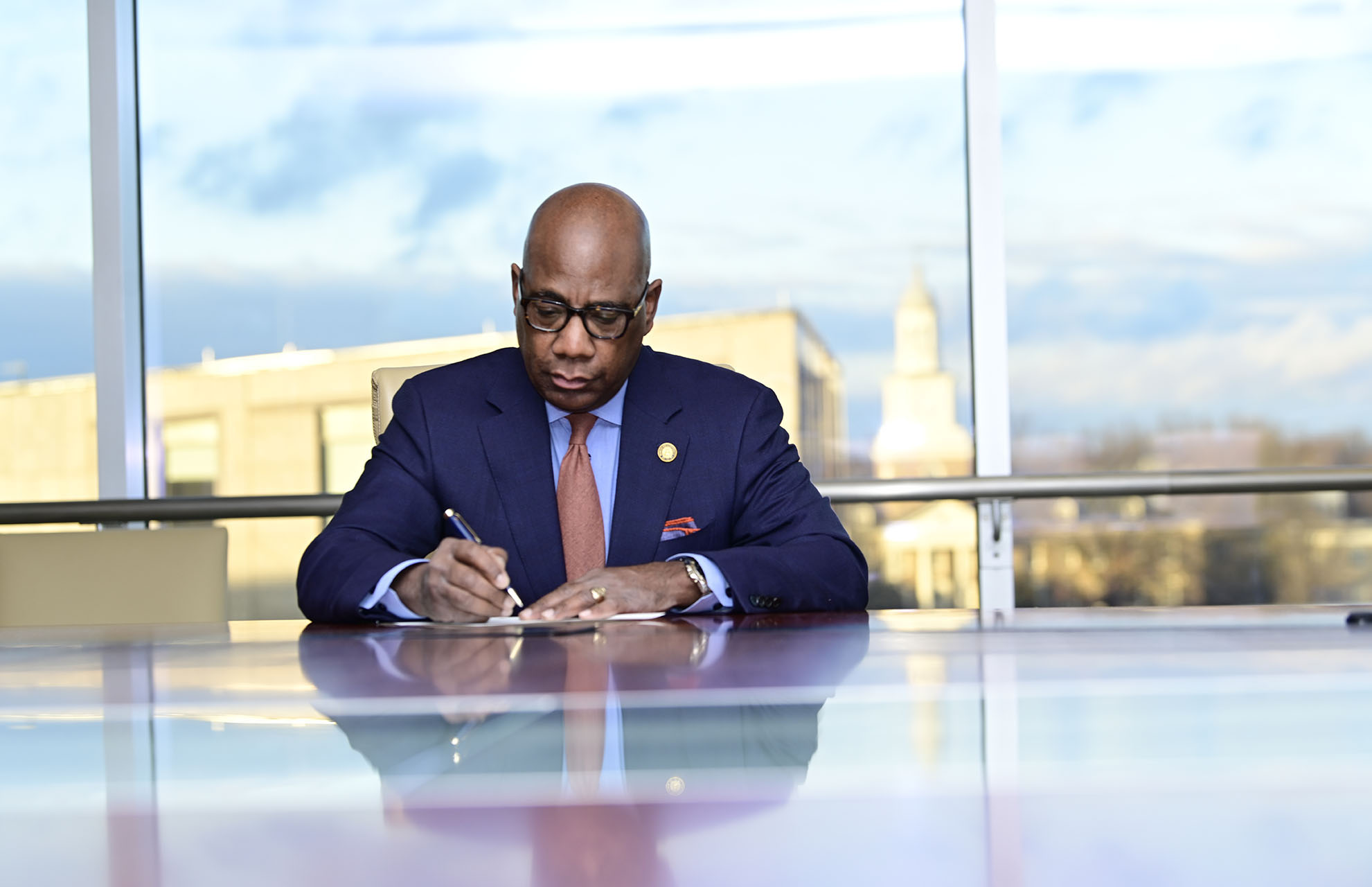 President Wilson at a conference table writing