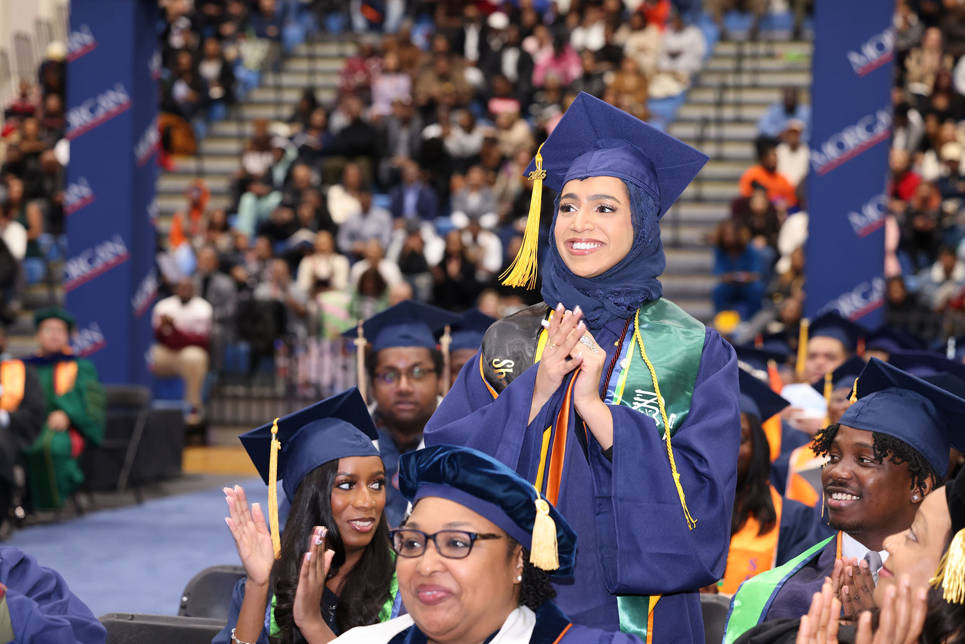 female graduate standing and smiling