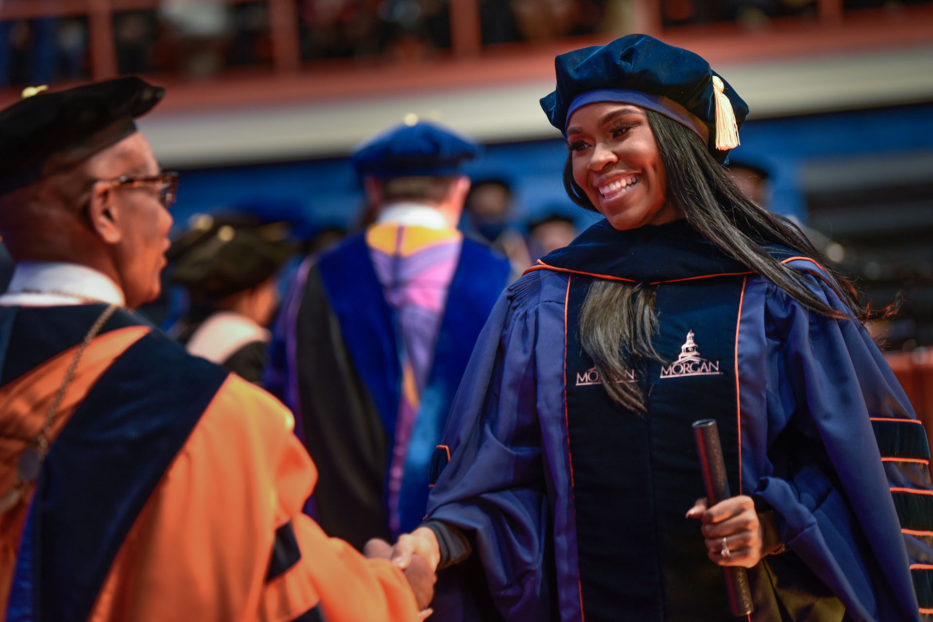 female graduate shaking hands with President Wilson