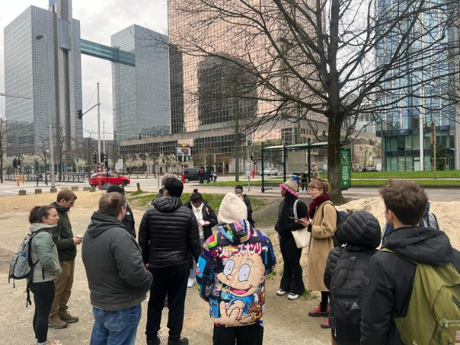 group of students and faculty standing outside in a plaza