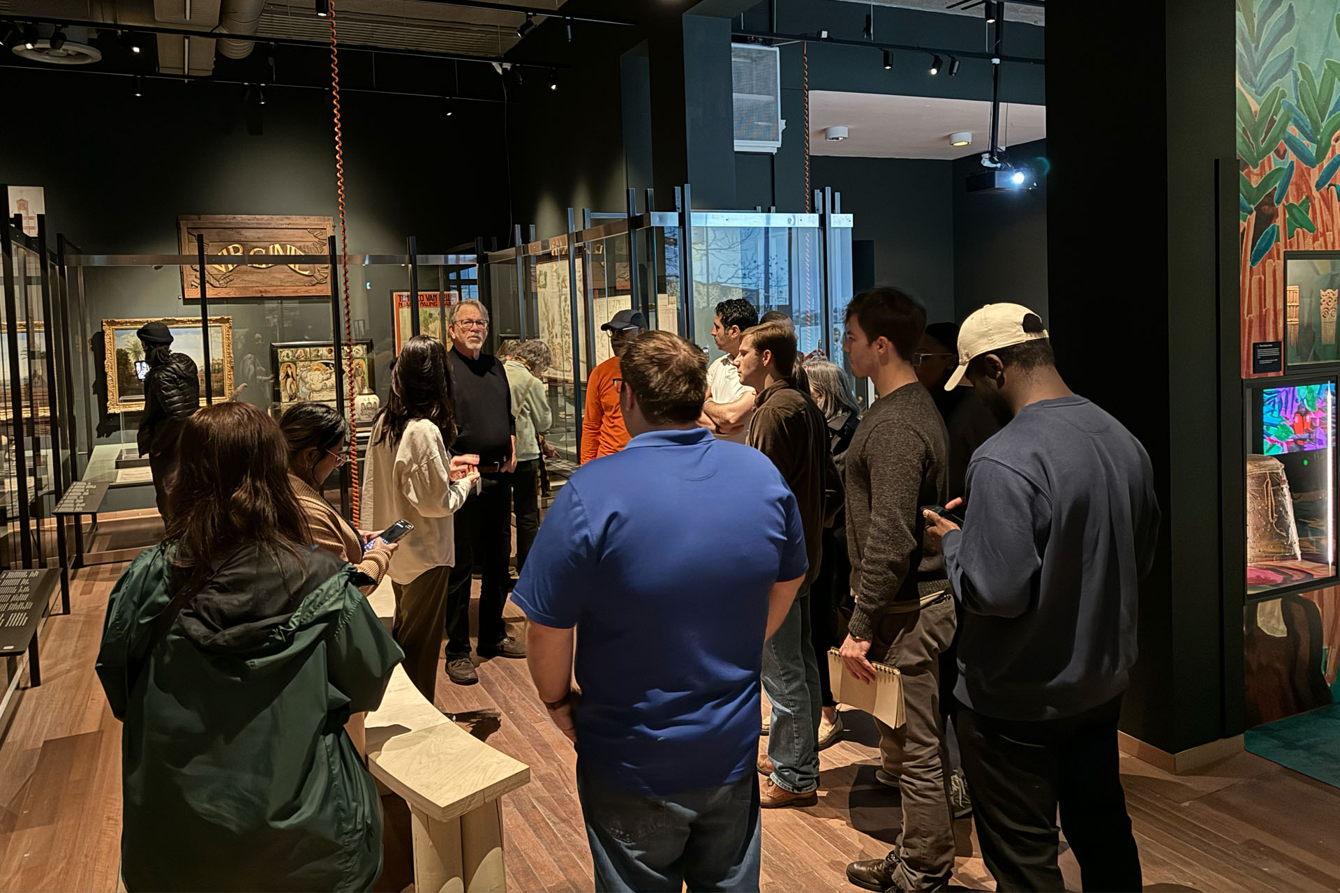 group of students and faculty standing in a museum gallery