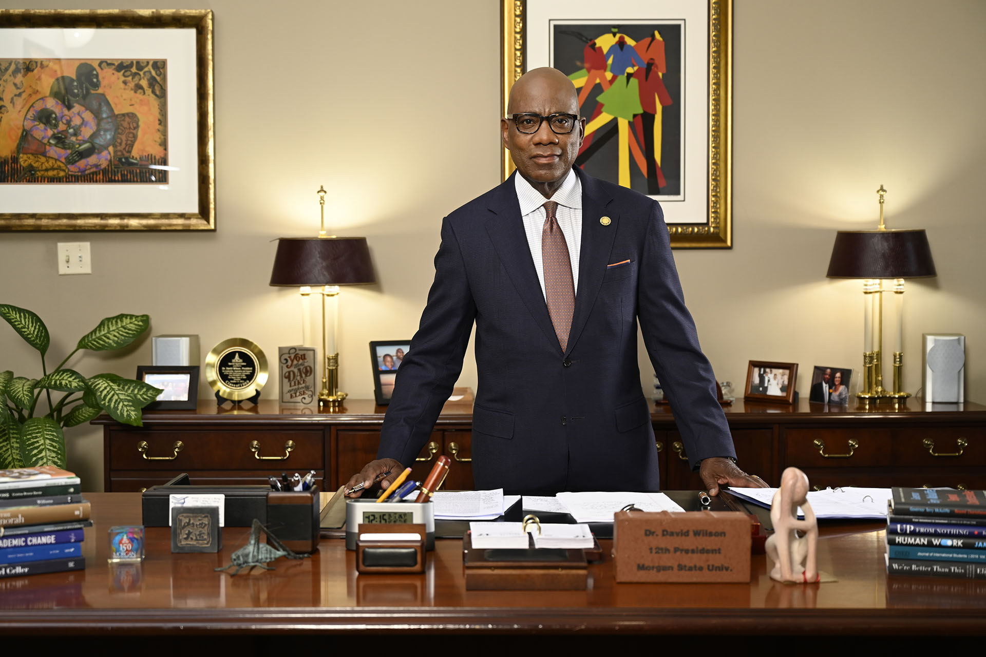 President David Wilson standing behind his desk